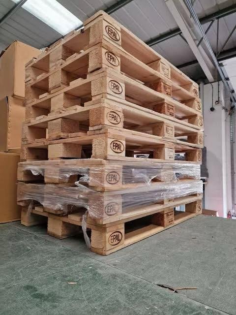 Wooden pallets stacked inside a warehouse